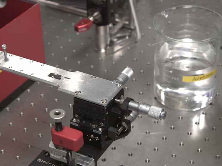Fabrication of 1-D Photonic Crystal Cavity on a Nanofiber Using Femtosecond Laser-induced Ablation